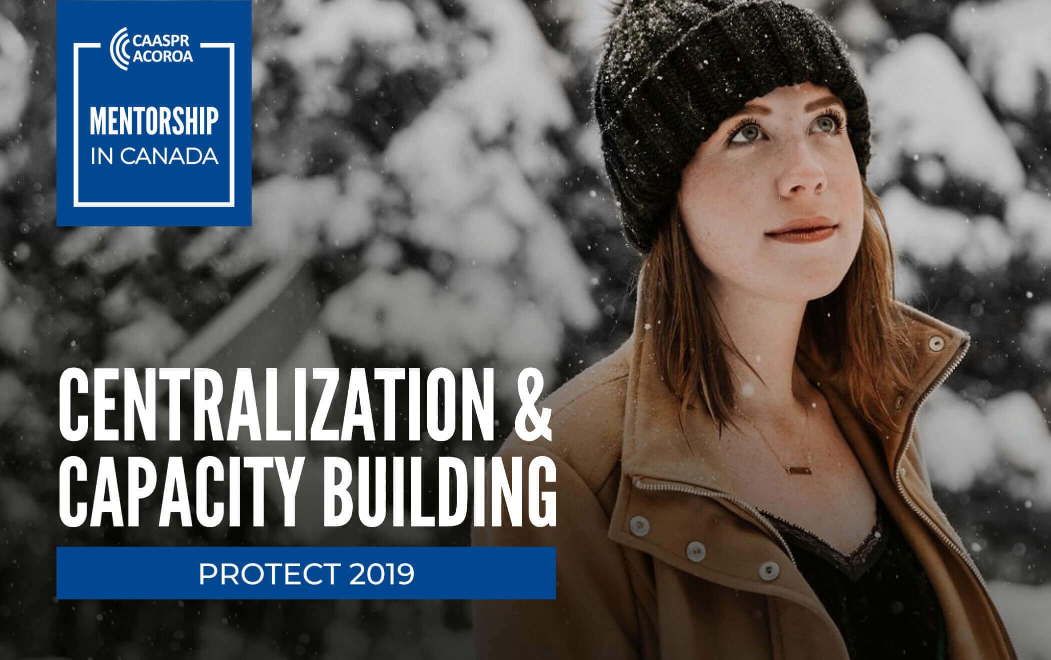 woman standing beside an out of focus pine tree covered in snow